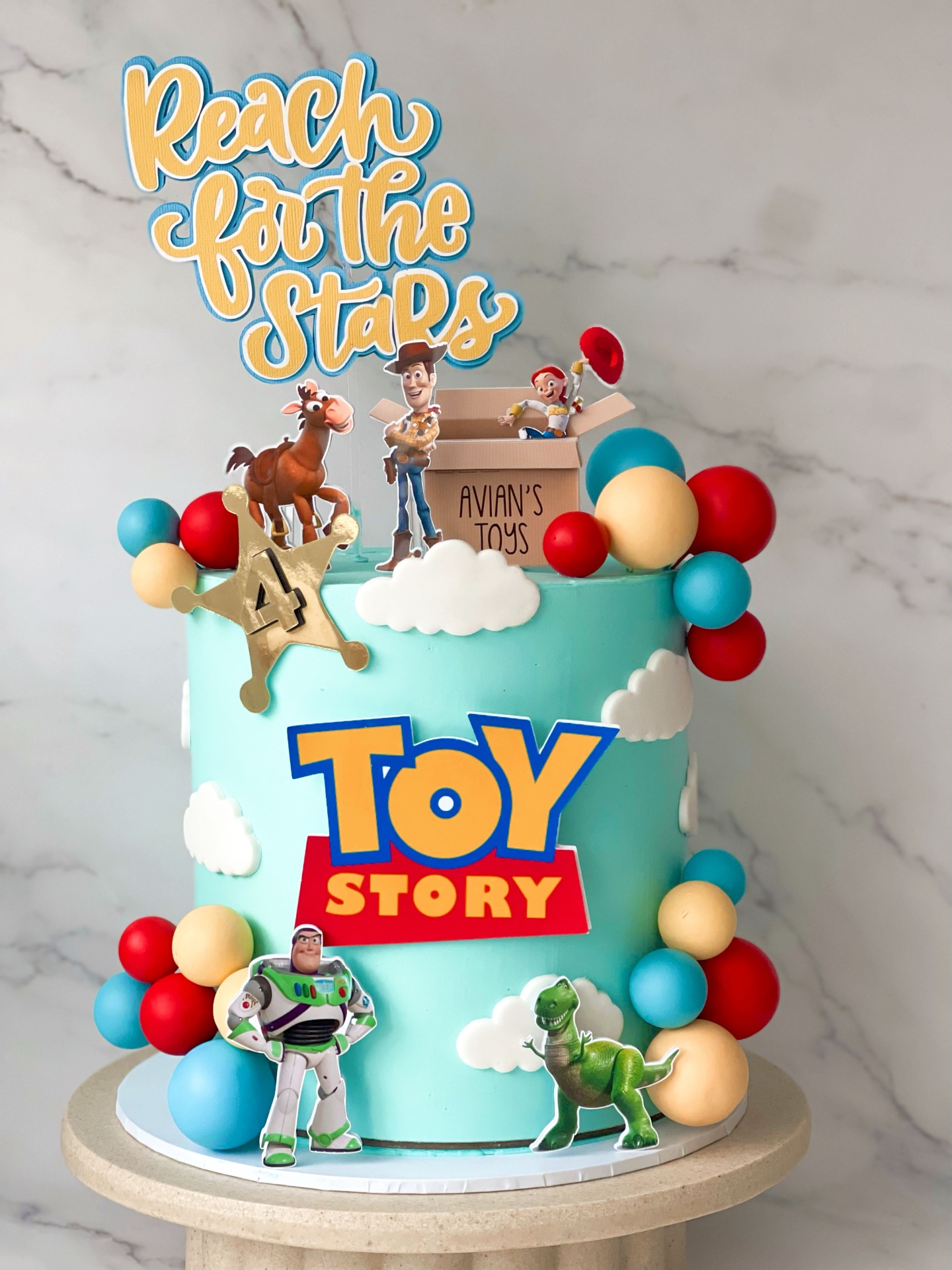Toy Story themed birthday cake with Woody, Buzz and Reach for the Stars topper